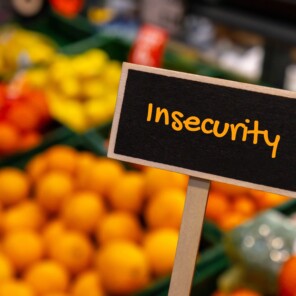 Insecurity sign in front of fruit at a market