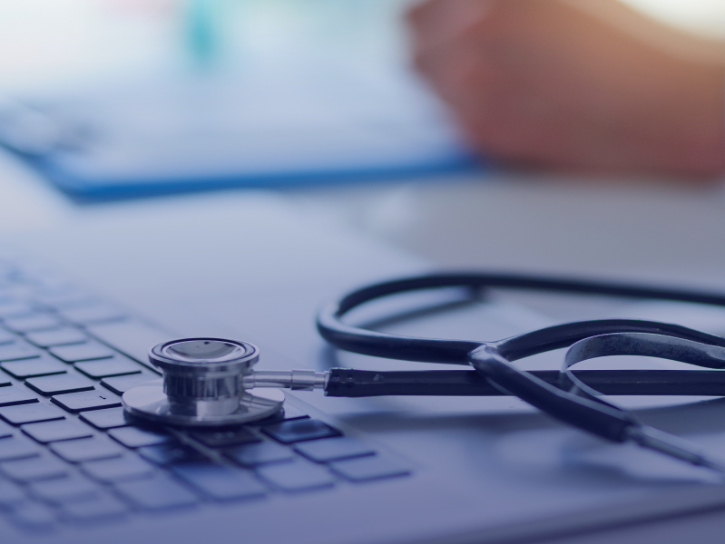 Stethoscope on keyboard of laptop