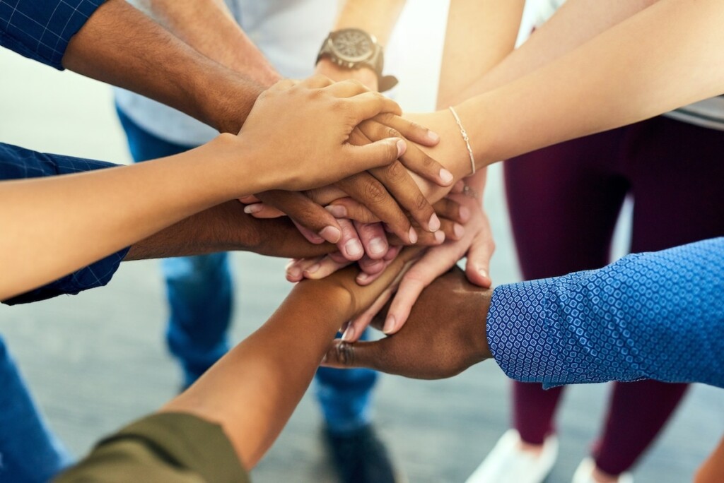 Diverse group of hands stacked